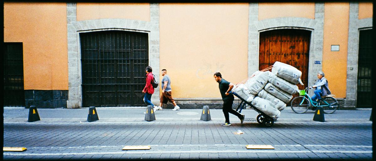 analog panoramic street photograph of people walking in Mexico City’s historic centre